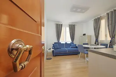 a door to a living room with a blue couch at MM Luxury Apartment in Rome