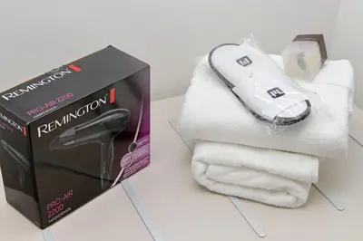 a remote control next to a pile of towels at MM Luxury Apartment in Rome