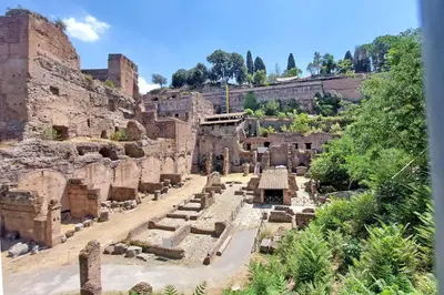 ancient ruins of a building with trees in the background at MM Luxury Apartment in Rome