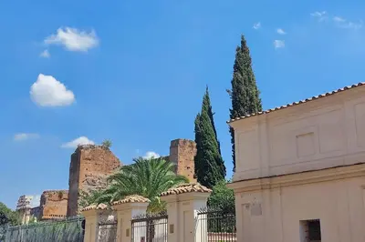 a fence in front of a building with two trees at MM Luxury Apartment in Rome