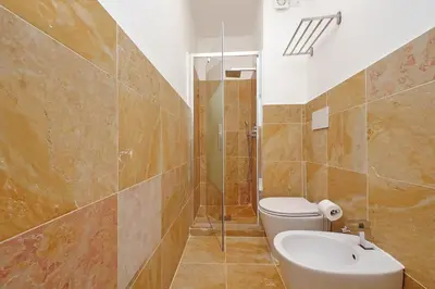 a bathroom with a toilet and a shower and a sink at MM Luxury Apartment in Rome