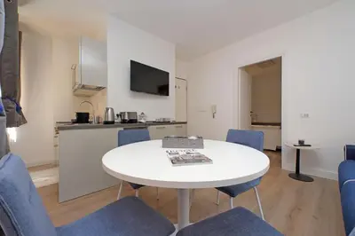 a room with a white table and blue chairs at MM Luxury Apartment in Rome