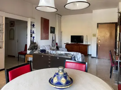 a living room with a table and red chairs at Casa di Alfredo -Appartamento Musei Vaticani in Rome