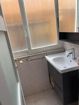 a glass table with plates on top of it at Tiburtino Apartment in Rome