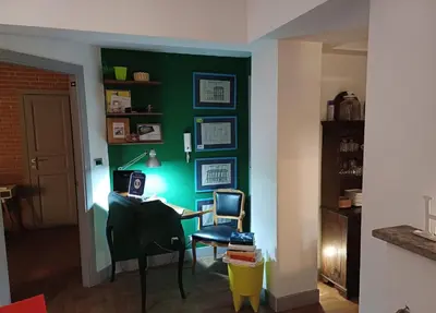 a room with a desk and a green wall at Il Giardino del Viaggiatore in Rome