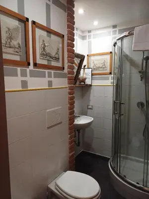 a bathroom with a shower and a toilet and a sink at Il Giardino del Viaggiatore in Rome