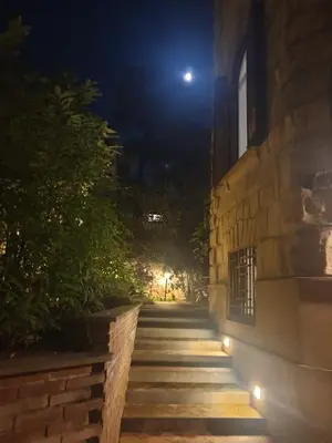 a building at night with a moon in the sky at Il Giardino del Viaggiatore in Rome