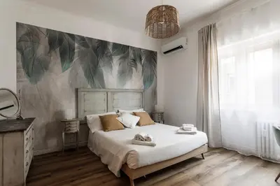a bedroom with a bed with a painting on the wall at Aurelia 386 Vatican House in Rome