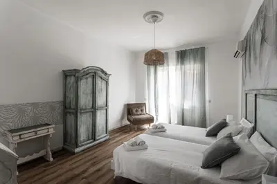 a dining room with a wooden table and a kitchen at Aurelia 386 Vatican House in Rome