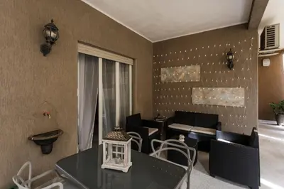 a balcony with chairs and a table on a building at Aurelia 386 Vatican House in Rome