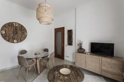 a living room with a table and a tv at Aurelia 386 Vatican House in Rome