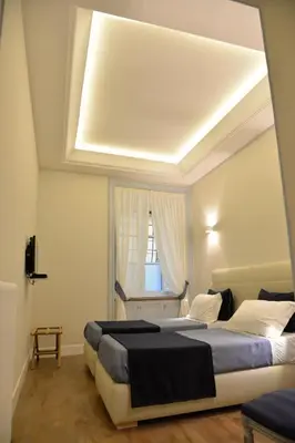 a bedroom with two beds and a window at Little Rose Residence in Rome