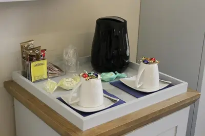 a shelf with two white plates and a black vase at Little Rose Residence in Rome