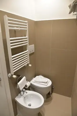 a small bathroom with a toilet and a sink at Little Rose Residence in Rome
