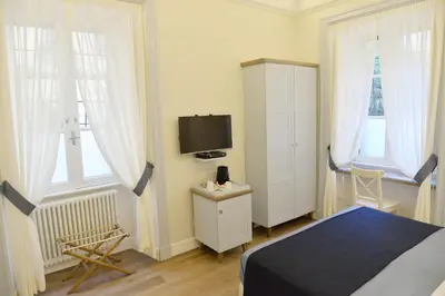 a bedroom with a bed and a tv in it at Little Rose Residence in Rome