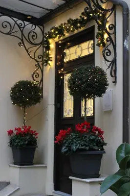 a front door with flowers and christmas lights at Little Rose Residence in Rome