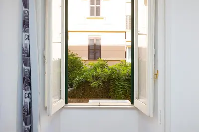 an open window with a view of a building at Faleria Second by Rental in Rome in Rome