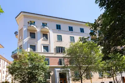 a large white building with windows and trees at Faleria Second by Rental in Rome in Rome