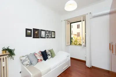 a white living room with a white couch and a window at Faleria Second by Rental in Rome in Rome