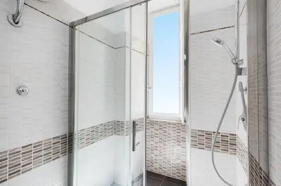 a shower with a glass door in a bathroom at Faleria Second by Rental in Rome in Rome