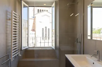a bathroom with a sink and a shower with a window at Testaccio by Rental in Rome in Rome