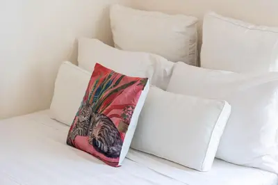 a pillow sitting on a bed with white pillows at Campani by Rental in Rome in Rome