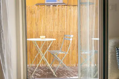 a glass door with a table and a chair outside at Campani by Rental in Rome in Rome