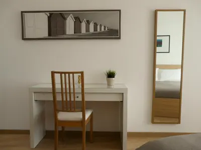 a desk with a chair and a mirror on a wall at Atticoromantica in Rome