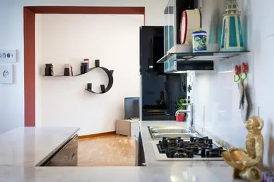 a kitchen with a sink and a stove top oven at Ripa by Rental in Rome in Rome