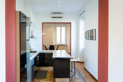 a kitchen with a table and a counter top at Ripa by Rental in Rome in Rome