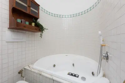 a bath tub in a bathroom with white tiles at Ripa by Rental in Rome in Rome