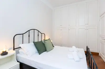 a bedroom with a white bed with green pillows at Ripa by Rental in Rome in Rome