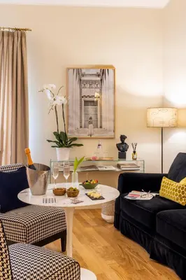 a living room with a table and a couch at Nerva Boutique Hotel in Rome