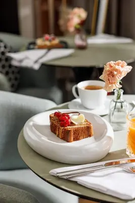a plate of toast with fruit and a cup of coffee at Nerva Boutique Hotel in Rome