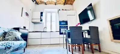 a kitchen with a table and chairs in a room at Cozy Flat near the Vatican! in Rome