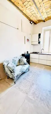 a bedroom with a bed and a kitchen at Cozy Flat near the Vatican! in Rome
