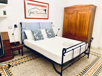 a bedroom with a bed and a wooden cabinet at Cozy Flat near the Vatican! in Rome