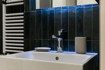 a bathroom sink with a faucet and a bowl on it at Del Frate Guest House Vatican in Rome