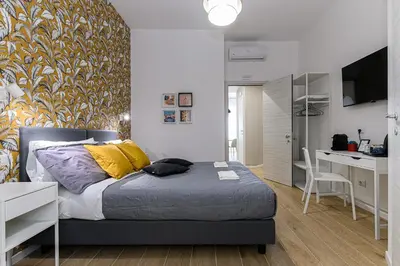 a bedroom with a bed and a desk in it at Del Frate Guest House Vatican in Rome