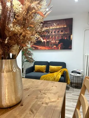 a living room with a table and a couch at Casa Domus Mea - garden addicted in Rome