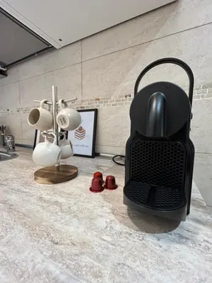 a table with three framed pictures and a lamp at Casa Domus Mea - garden addicted in Rome