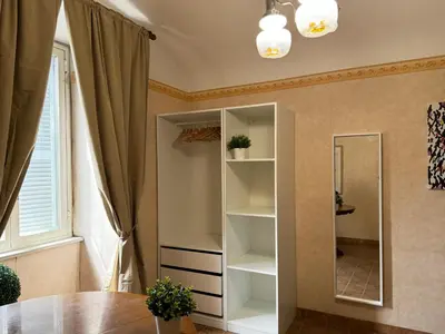 a dressing room with a mirror and a table at Campani Termini Apartment in Rome