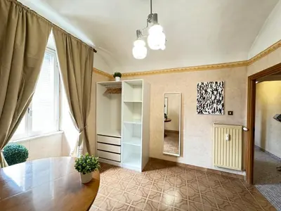 a living room with a table and a mirror at Campani Termini Apartment in Rome