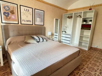 a bedroom with a bed and some pictures on the wall at Campani Termini Apartment in Rome