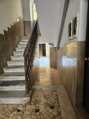 a staircase in a building with a stone floor at Campani Termini Apartment in Rome