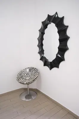 a chair and a mirror on a wall at Roman Forum Holiday Termini in Rome