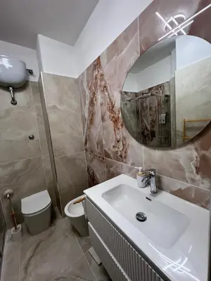 a bathroom with a sink and a toilet and a mirror at Roman Forum Holiday Termini in Rome