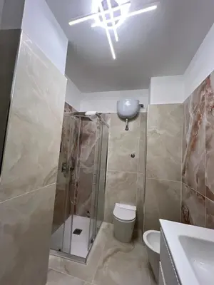 a bathroom with a shower and a toilet and a sink at Roman Forum Holiday Termini in Rome