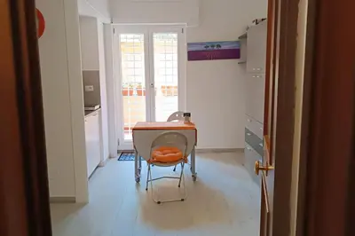 a kitchen with a table and a chair in a room at Vatican tiny house by Gialel in Rome