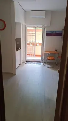 an empty room with a door open to a room with a table at Vatican tiny house by Gialel in Rome